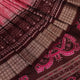 Close-up of peach and maroon Sambalpuri silk saree fabric showing intricate handloom texture and motifs.