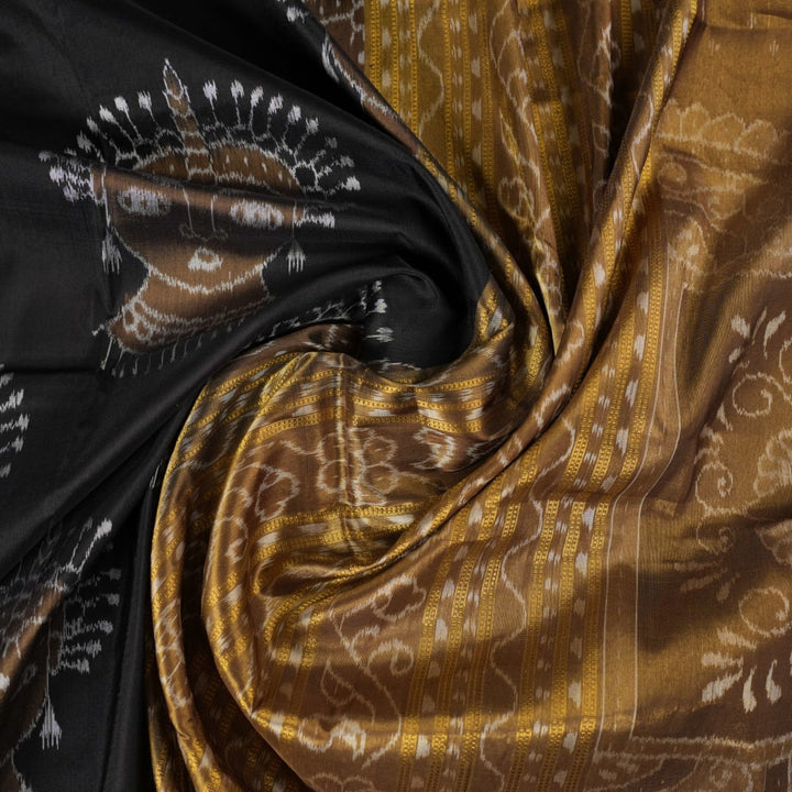 Close-up revealing the delicate, lustrous texture of the black silk tissue saree fabric with subtle sheen.