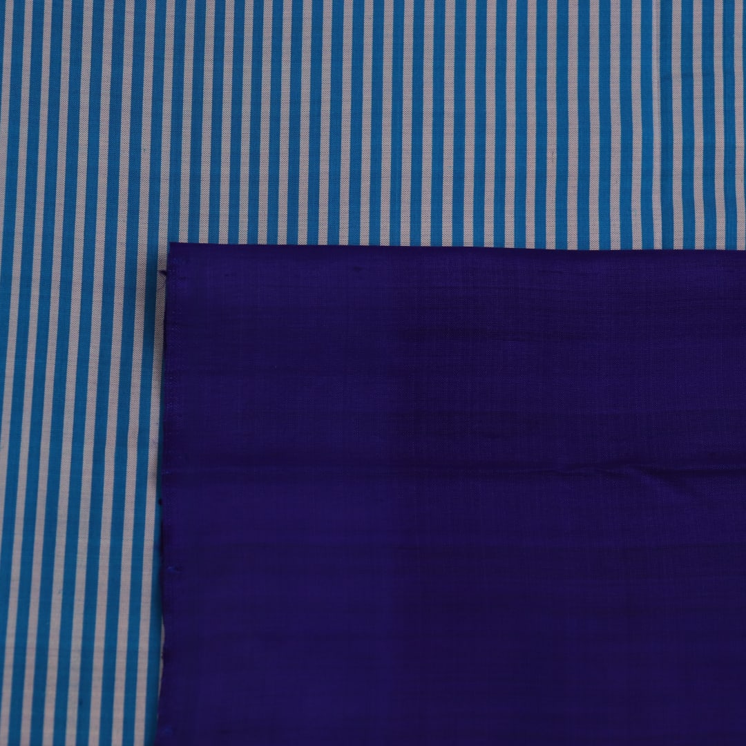 Full view of a blue Khandua silk saree featuring intricate motifs woven into the fabric.