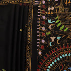 Close-up of the black silk Patachitra saree, showcasing the hand-painted fabric texture.