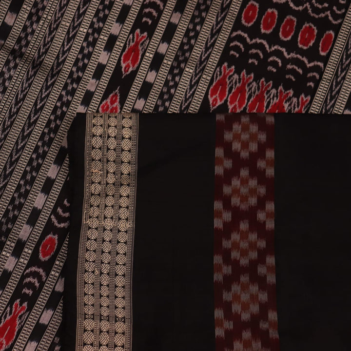 Close-up view of maroon and black silk Sambalpuri saree fabric showcasing intricate motifs