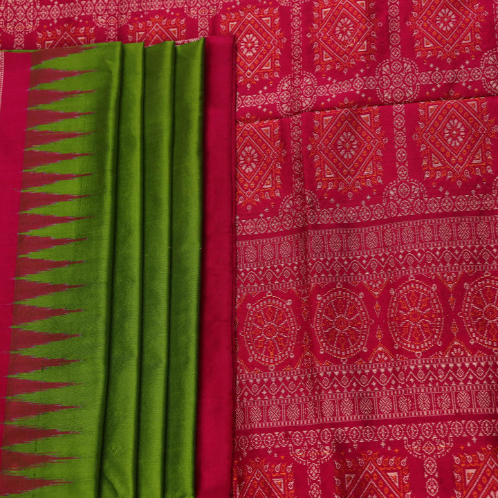 Textured close-up of green Bomkai silk saree fabric, revealing intricate weave and magenta butta pattern.