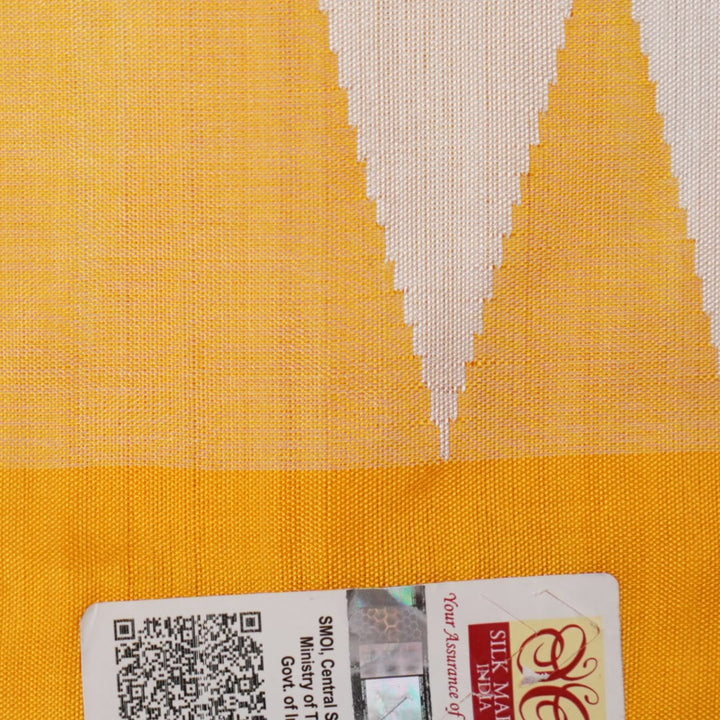 Close-up of the smooth texture and plain weave of white Sambalpuri silk fabric.