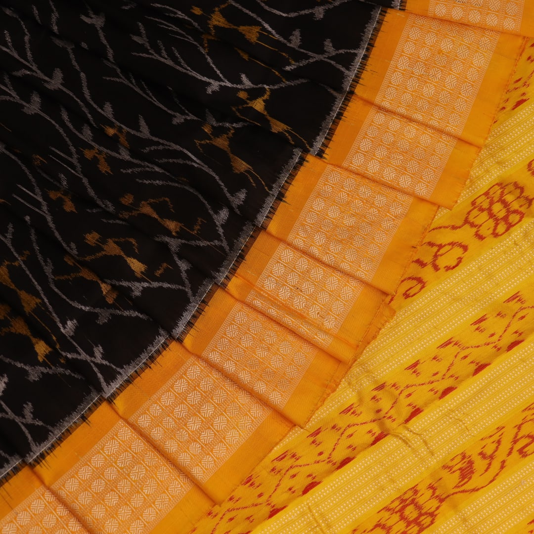 Close-up showcasing intricate silk fabric texture in black and yellow motifs