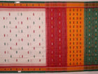 Full view of a white and green cotton handloom Bomkai saree with butta pattern.