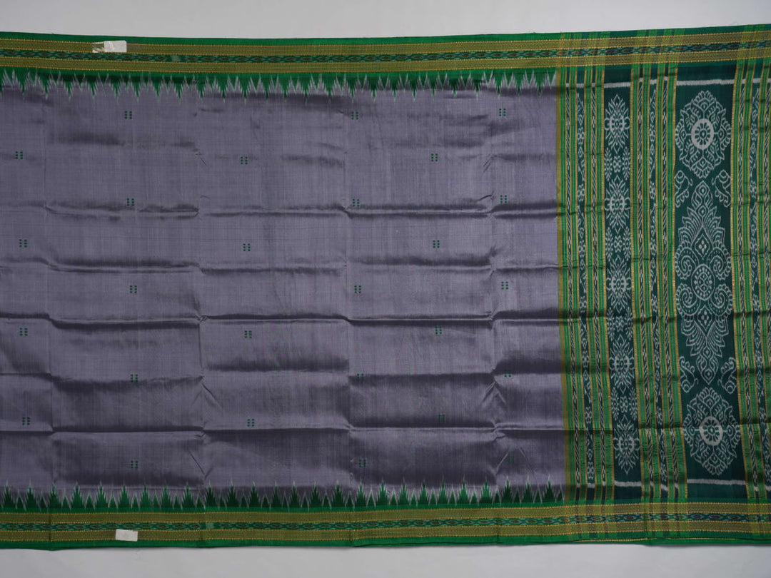 Model draped in a grey and green Khandua silk saree with butta pattern for a classic traditional look.
