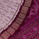 Close-up of silk fabric with intricate Sambalpuri motif design in multicolor and purple hues