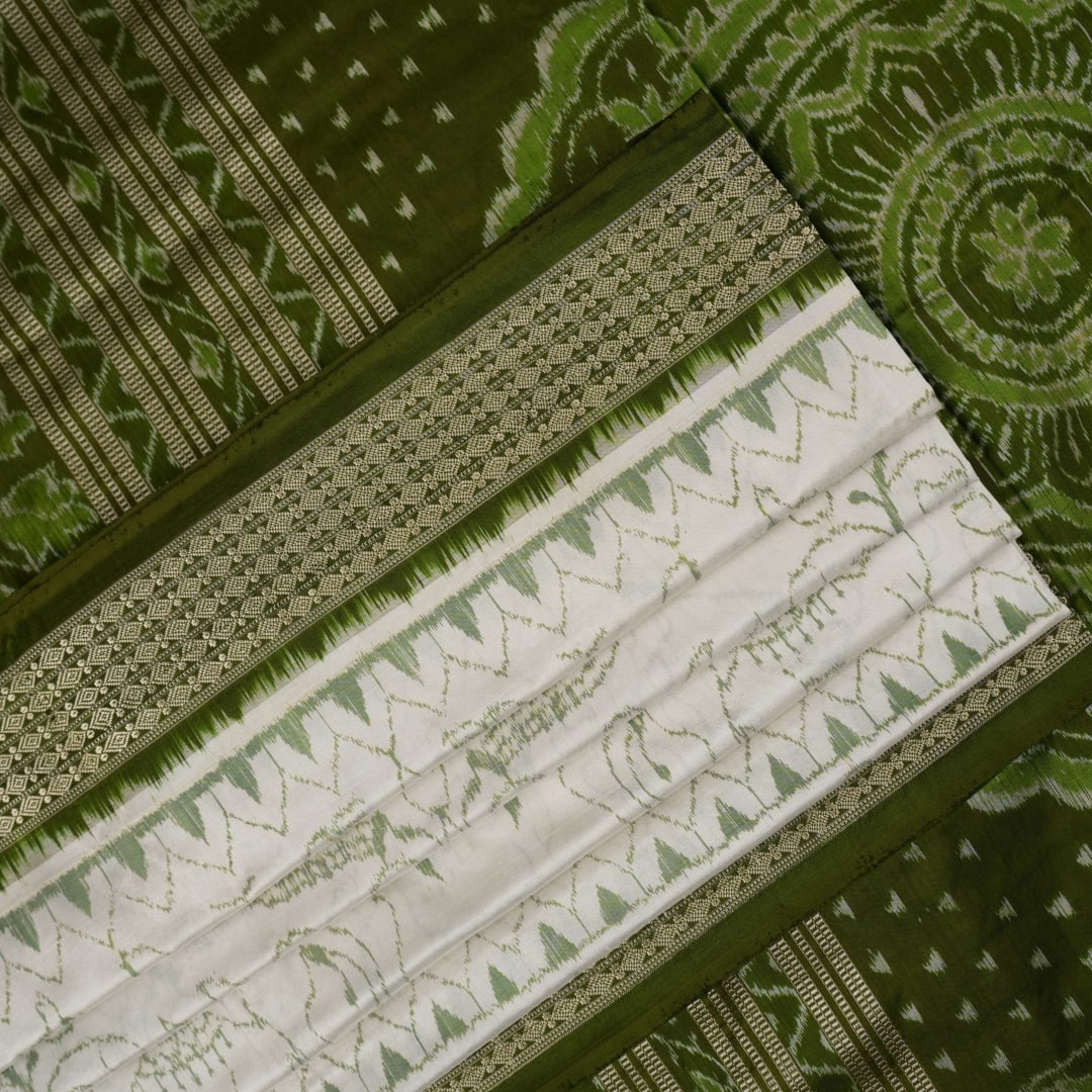 Close-up of the luxurious texture of the white Sambalpuri Silk Saree, revealing the fine weave and motif details.