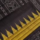 Close-up of the plain, slubby texture of a handwoven green and black Tussar silk saree.
