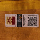 Close-up of the yellow printed Tussar silk saree's distinct slubby fabric texture.