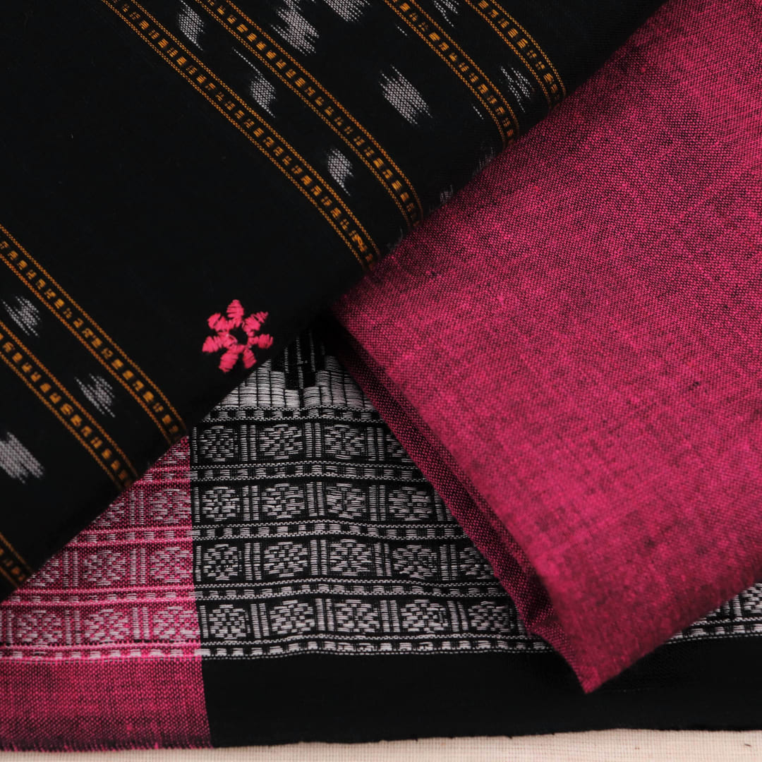 Close-up of blouse piece featuring intricate Sambalpuri motifs in black and magenta on a cotton base.