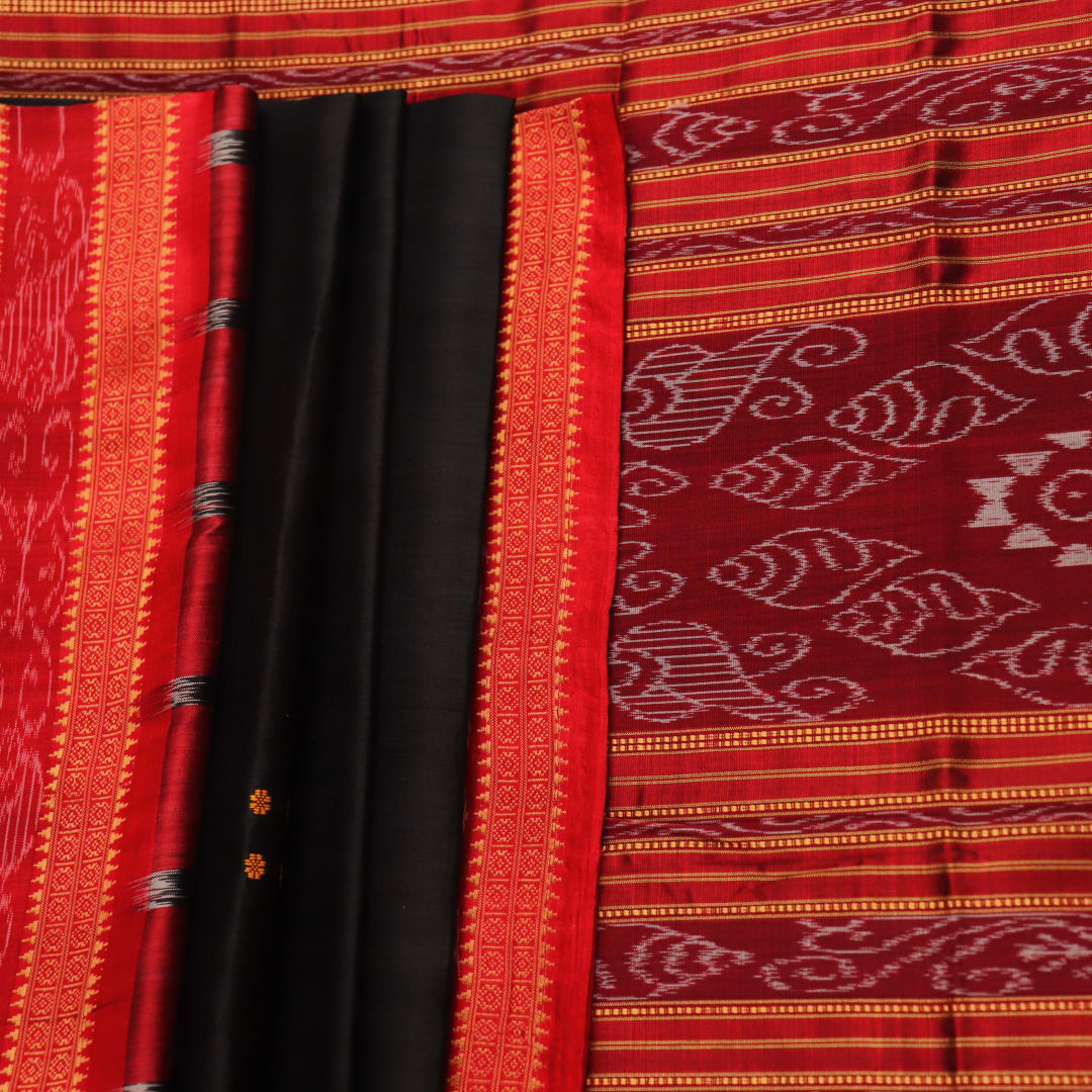 Draping view of a black Khandua silk saree with a red border and butta pattern