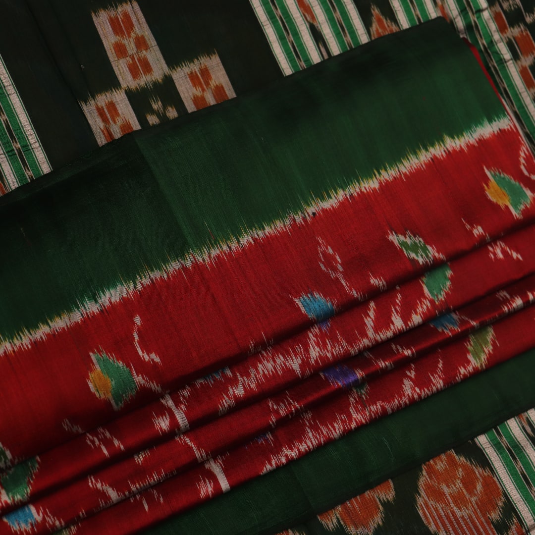 Maroon and green Khandua silk saree with intricate motifs draped elegantly