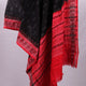 A model drapes a black Sambalpuri cotton dupatta with red motifs and pallu border.