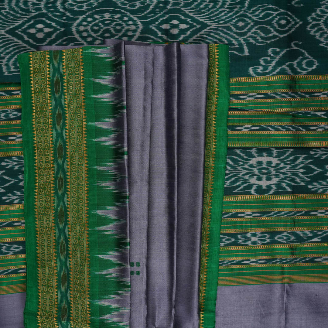 Model draped in a grey and green Khandua silk saree with butta pattern for a classic traditional look.