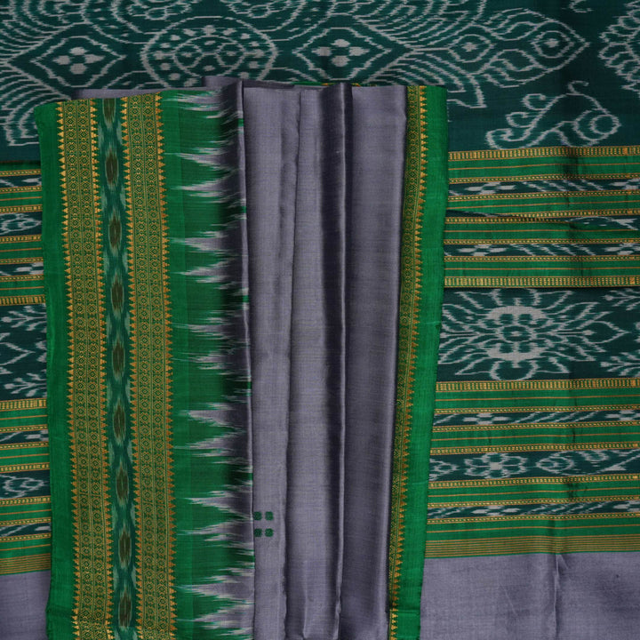 Model draped in a grey and green Khandua silk saree with butta pattern for a classic traditional look.