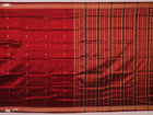Close-up of maroon Sambalpuri Silk Saree fabric, showing intricate butta weave texture.
