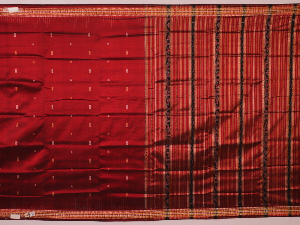 Close-up of maroon Sambalpuri Silk Saree fabric, showing intricate butta weave texture.