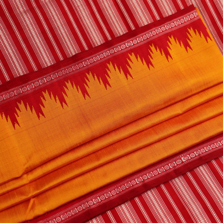 Close-up view of the smooth and lustrous silk fabric texture in a plain yellow Berhampuri saree.