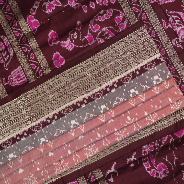 Close-up of the rich multi-color and maroon Sambalpuri silk fabric, highlighting its exquisite handloom weave texture.