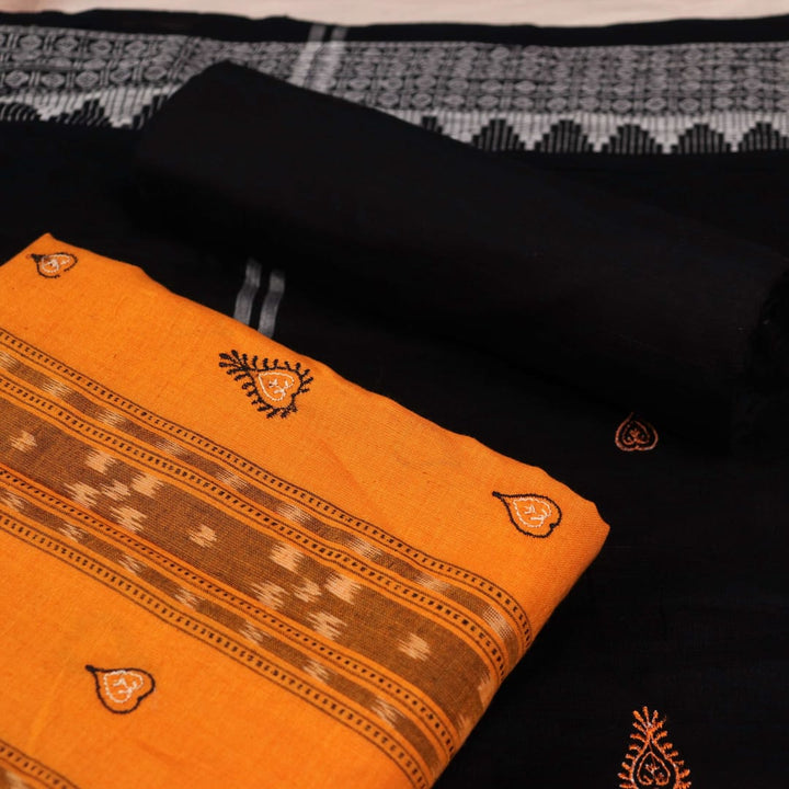 Close-up view of the blouse piece from a yellow and black cotton Sambalpuri dress material featuring motifs.