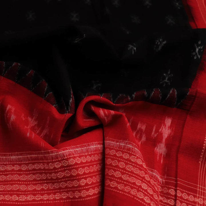 Close-up of a lightweight, black cotton Sambalpuri dupatta with red motifs in the border