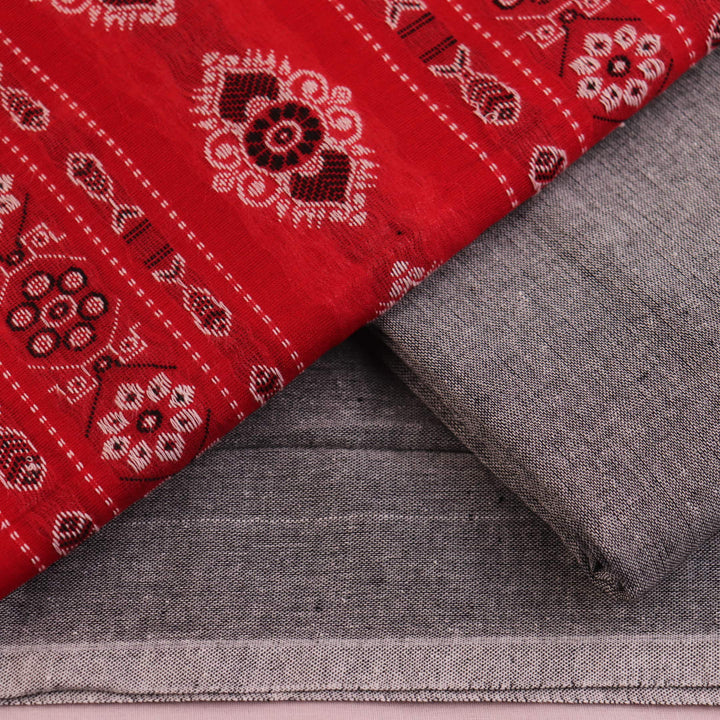 Close-up of the red and grey Bomkai cotton blouse piece with subtle pattern.