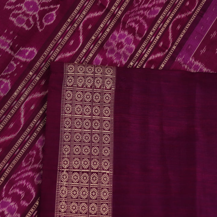 Close-up of silk fabric with intricate Sambalpuri motif design in multicolor and purple hues