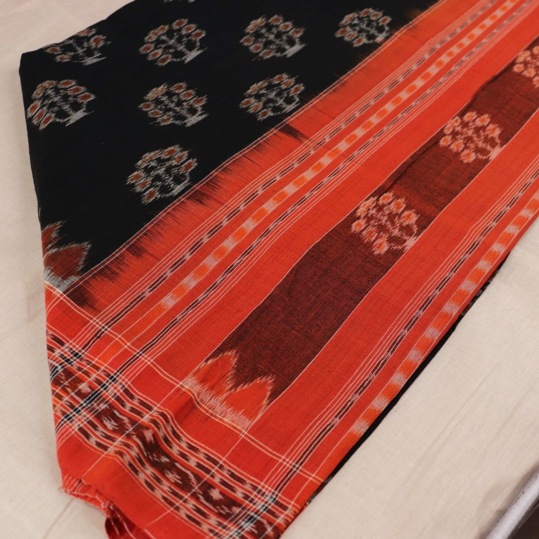 Black cotton Sambalpuri dupatta with rust motifs, styled on a mannequin