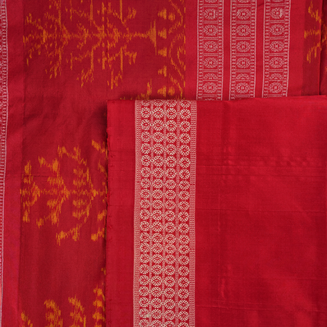 Close-up of the soft, lustrous grey Sambalpuri silk fabric texture, highlighting the intricate weave and motifs.
