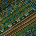 Elegant styling of a brown and green Khandua silk saree with butta work as draped on a model.