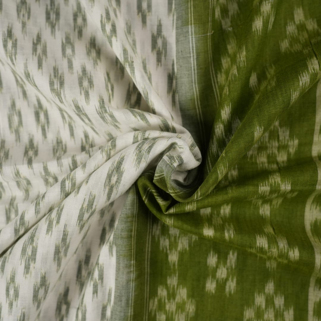 Model wearing a white and green Sambalpuri cotton saree, demonstrating the elegant drape and handloom motifs.
