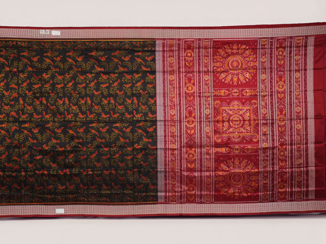 Close-up of Sambalpuri silk fabric texture, highlighting fine handloom weave in black and maroon.
