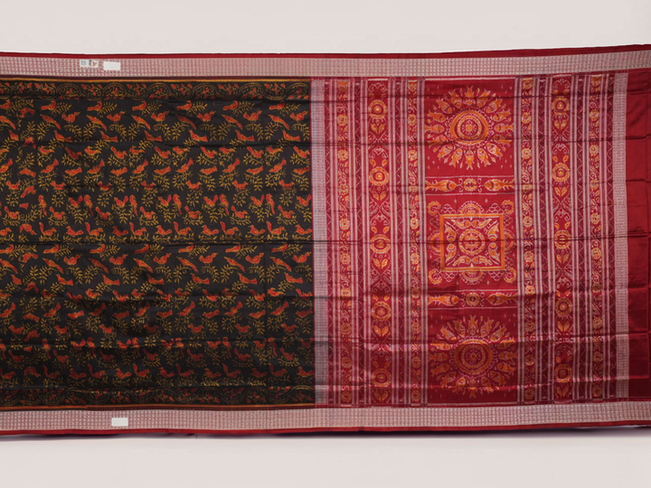 Close-up of Sambalpuri silk fabric texture, highlighting fine handloom weave in black and maroon.