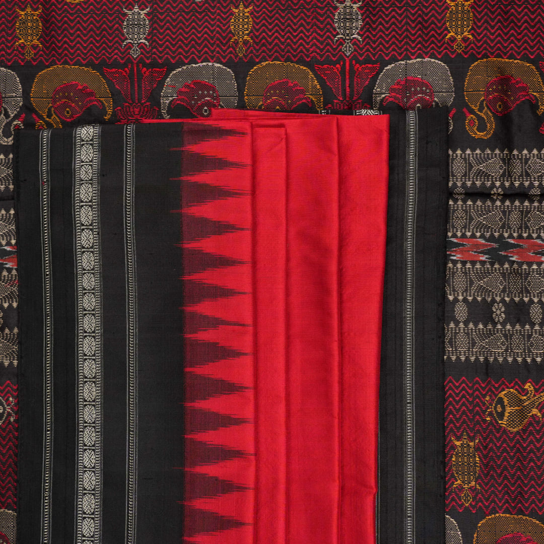 Extreme close-up revealing the fine handloom texture and intricate weave of the Bomkai silk fabric.