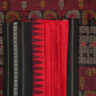 Extreme close-up revealing the fine handloom texture and intricate weave of the Bomkai silk fabric.