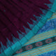 Close-up of the textured weave of a purple Sambalpuri silk saree with green accents and butta pattern.