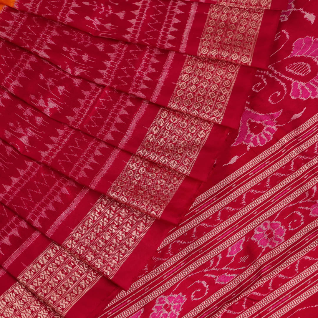 Close-up of intricate sambalpuri silk saree's yellow fabric featuring detailed motifs in rani color