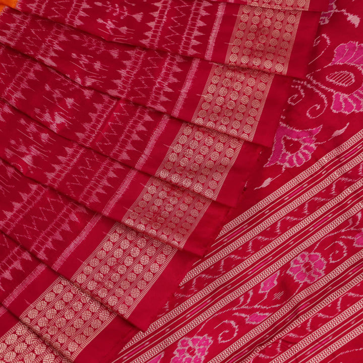 Close-up of intricate sambalpuri silk saree's yellow fabric featuring detailed motifs in rani color