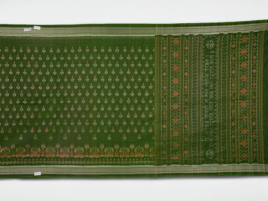 Ultra close-up of green Sambalpuri silk fabric, revealing its unique texture and fine weave.