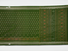 Ultra close-up of green Sambalpuri silk fabric, revealing its unique texture and fine weave.
