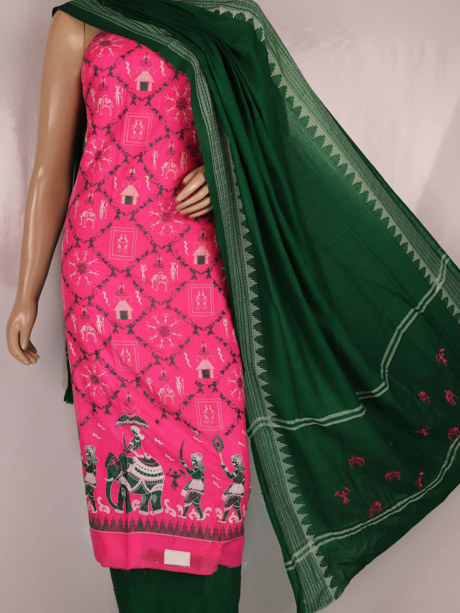 Close-up of the green and pink fabric texture of a Sambalpuri cotton dress material, featuring a repeating doll pattern.