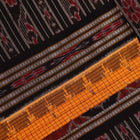 Model draped in a yellow and black cotton Sambalpuri saree with intricate motifs