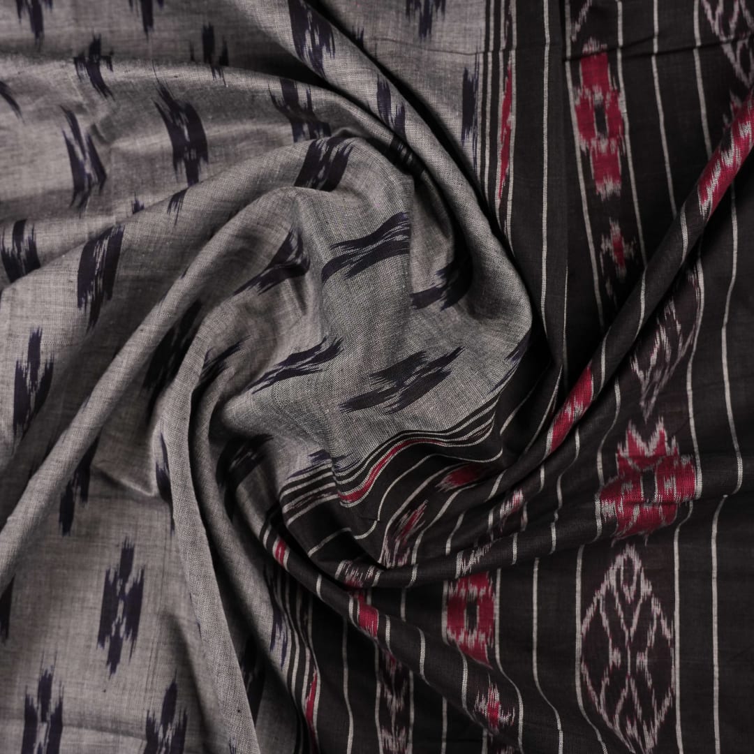 Model styled in a grey and black Sambalpuri cotton saree showing the elegant drape and traditional motifs.