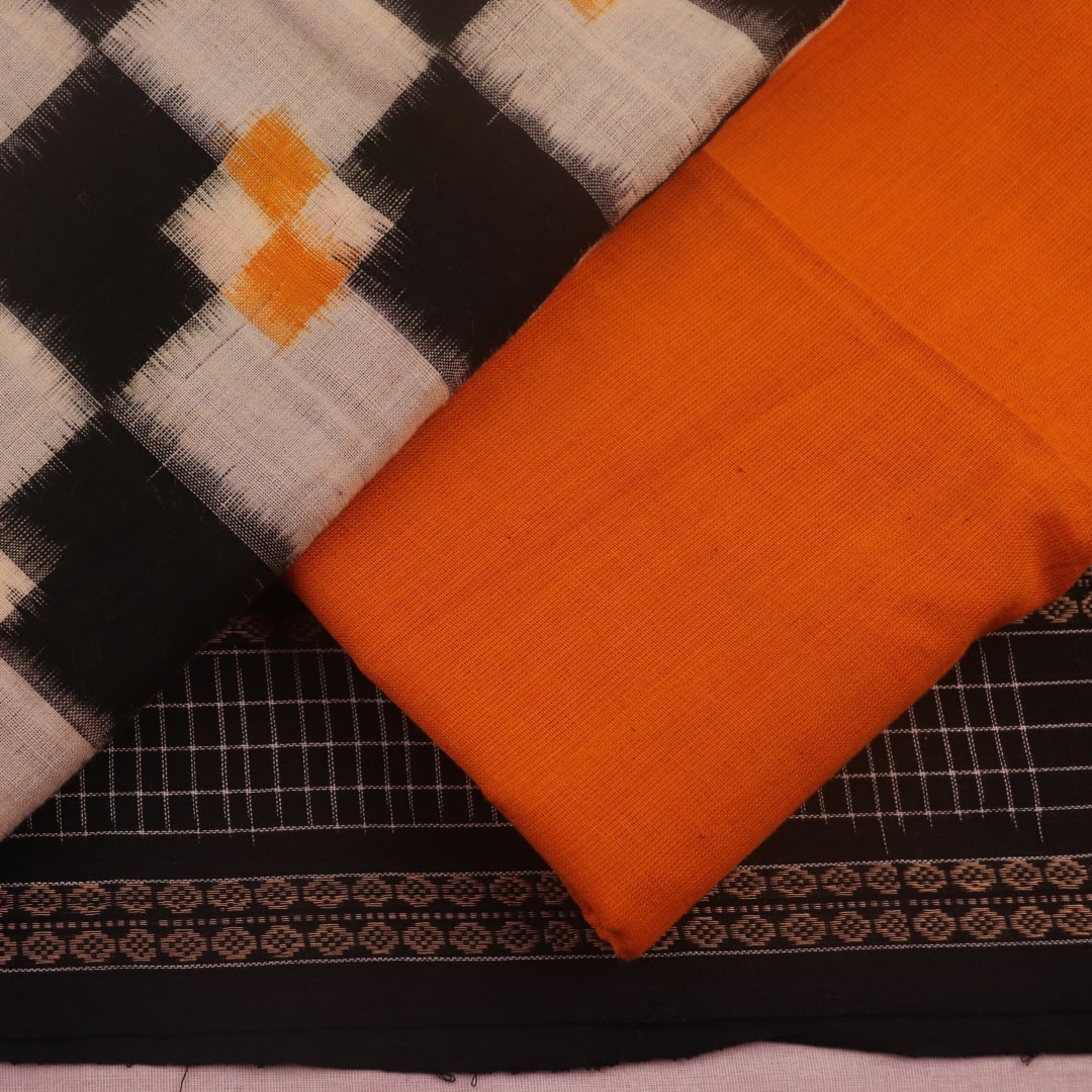 Detail of the white and yellow Sambalpuri cotton dress material blouse piece, showing motifs.