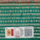 Extreme close-up of the rich orange Sambalpuri silk fabric, highlighting its intricate handloom weave texture.