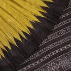Close-up of the plain, slubby texture of a handwoven green and black Tussar silk saree.