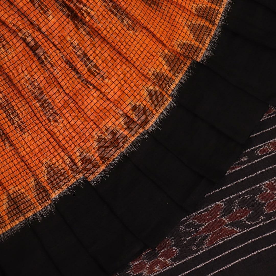 Woman draped in a yellow and black Sambalpuri cotton saree, showcasing the stylish drape and motif pattern.