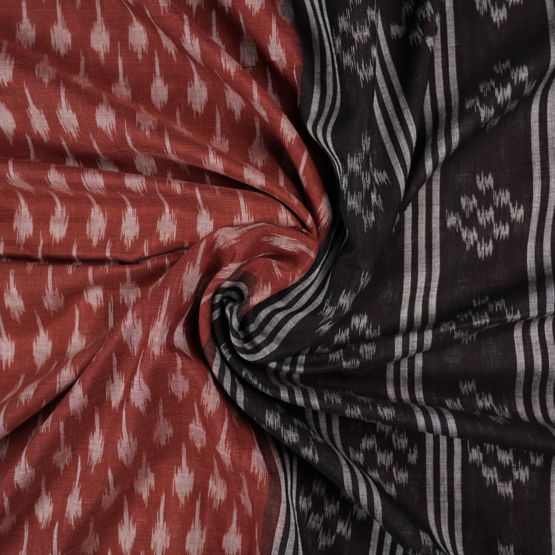 Full styling view of a model draped in a brown and black Sambalpuri cotton saree with traditional motifs.