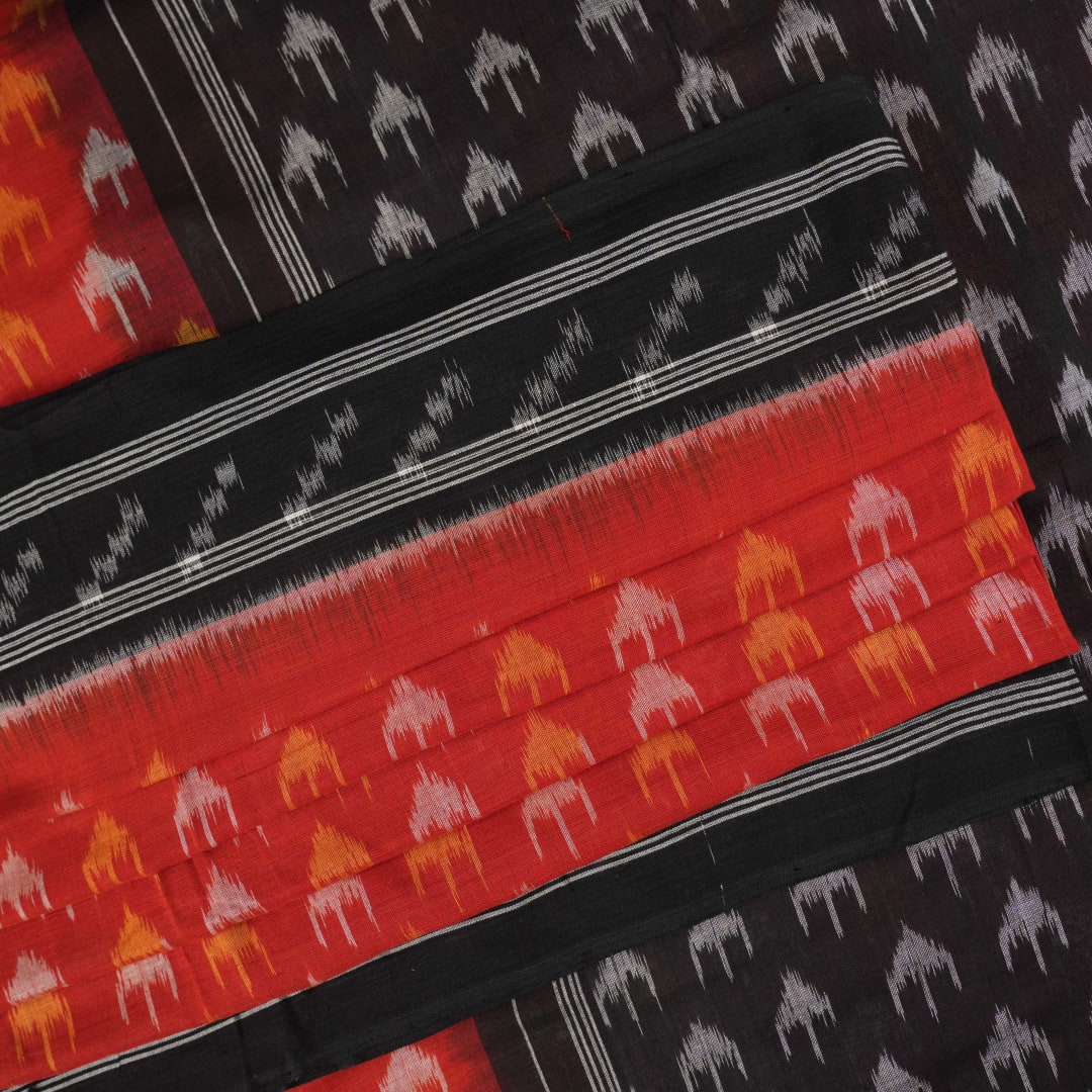 Model wearing a rust and black Sambalpuri cotton saree styled with traditional Odisha handloom motifs.